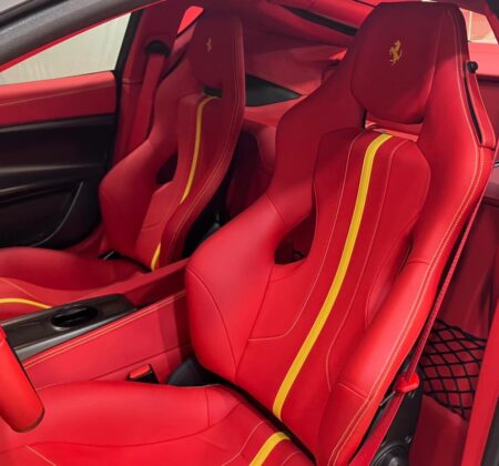 Rosso passion igniting a carbon-fiber cockpit.